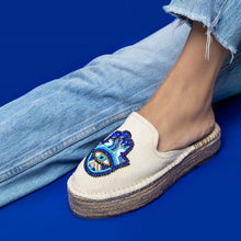 Load image into Gallery viewer, a woman's feet wearing Hamsa off-white espadrilles platforms in a pair of denim jeans, having evil eye protector design