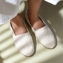 Load image into Gallery viewer, close up shot of a woman wearing white shoes against a wall with the sunlight casting behind her