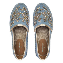 Load image into Gallery viewer, A pair of blue Espadrilles with a small embroidery of gold detailing on them with a pattern around the bottom and sides on a white background.