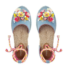 Load image into Gallery viewer, A pair of blue carnation Tie-up Espadrilles, featuring colorful flowers and straps on a white background.