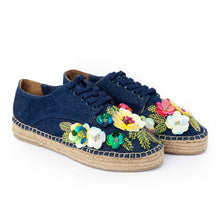 Load image into Gallery viewer, A pair of blue espadrilles decorated with colorful flowers on a white background.