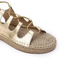 Load image into Gallery viewer, Photo of a single gold Gladiator Sandals featuring metallic gold straps on a white background.