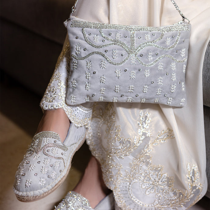 A women posing with beautiful Kaira Silver Bag exclusive handbags for women along with matching pair of shoes.