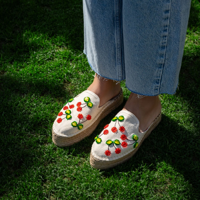 A woman wearing beautiful offwhite ladies shoes.