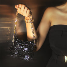 Load image into Gallery viewer, A woman flaunting with an elegant Sitara micro bag black and posing it by holding it in right hand.
