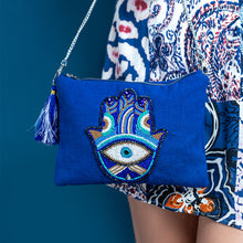 Load image into Gallery viewer, A women posing with beautiful Hamsa Bag Blue handbags for women.
