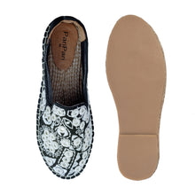 Load image into Gallery viewer, A pair of Nomad Espadrilles Black shoes for women, against a white background where one is shown from the sole side.
