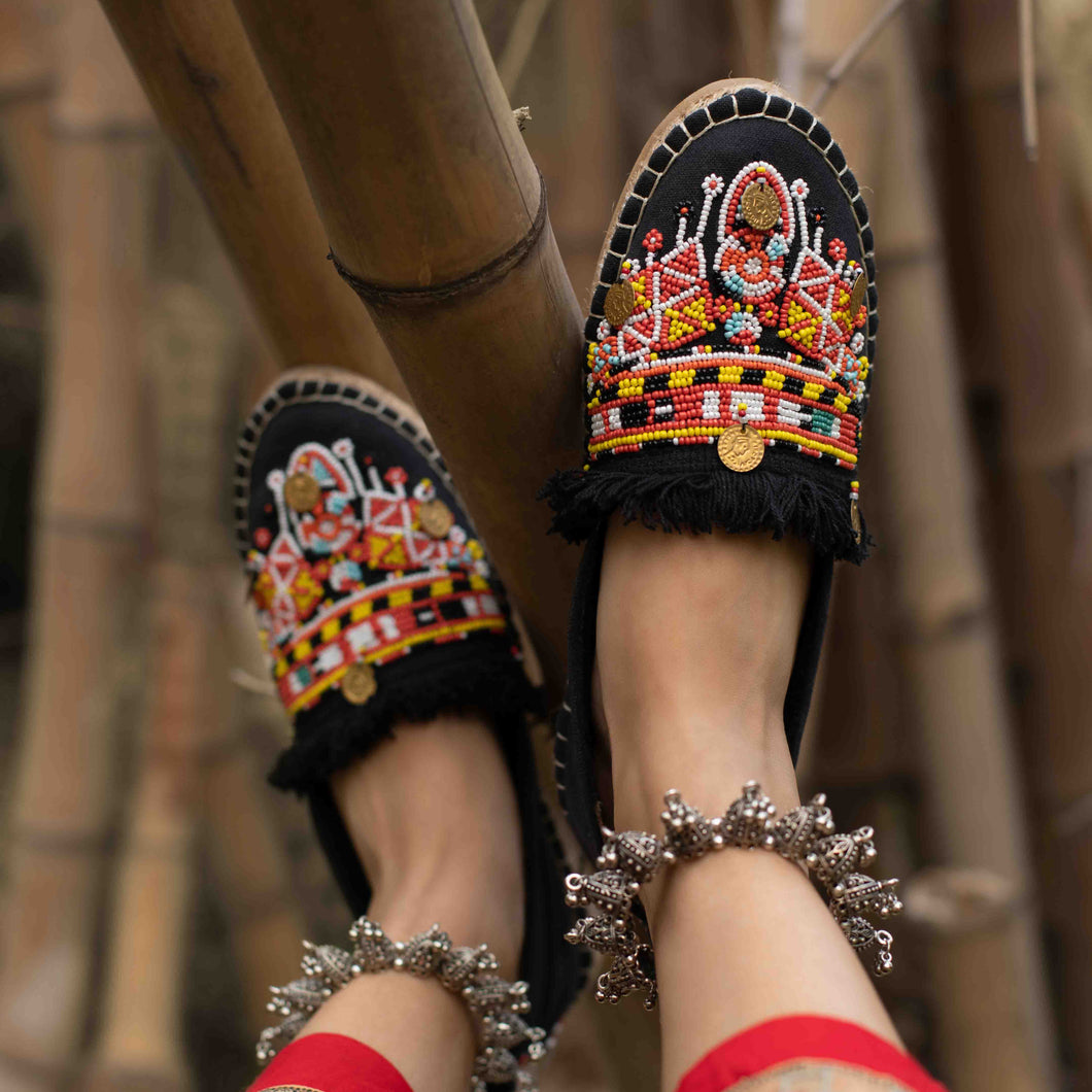 A feet of a model wearing beautiful Masai Beaded Espadrilles Black showcasing juttis for women