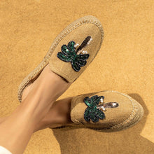 Load image into Gallery viewer, A model&#39;s cross legged feet wearing Coco Beige Espadrilles Platforms with palm tree design featuring footwear for women kept on a beige background
