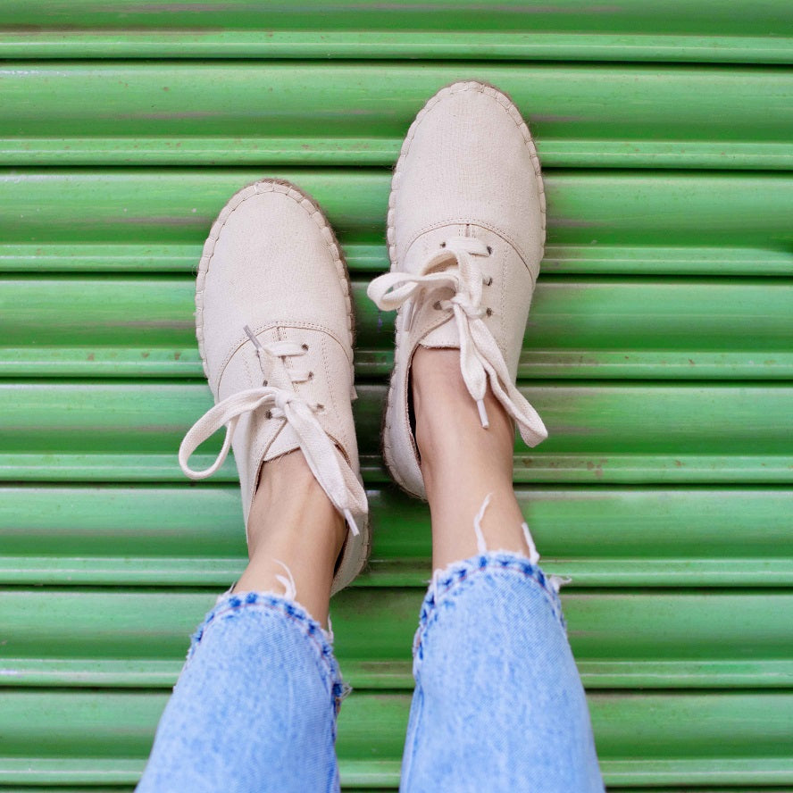 A feet of lady wearing a The Havana Lace-ups - Off-White Supportive Shoes for Women, shoes for women