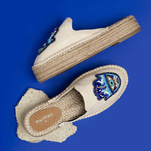 Load image into Gallery viewer, a pair of Hamsa off-white espadrilles platforms having evil eye protector design, kept on a blue background
