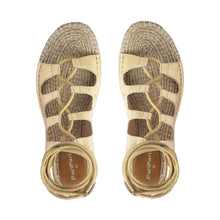 Load image into Gallery viewer, Photo of a pair of gold Gladiator Sandals featuring metallic gold straps on a white background.
