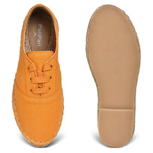 Load image into Gallery viewer, A pair of  The Walking Havana Lace-ups - Tangy Orange shoes for women, against a white background where one is shown from the sole side
