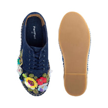 Load image into Gallery viewer, A pair of blue espadrilles decorated with colorful flowers, one view facing forward and the other view facing backwards on a white background.
