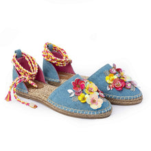 Load image into Gallery viewer, A pair of blue carnation Tie-up Espadrilles, featuring colorful flowers and straps on a white background.
